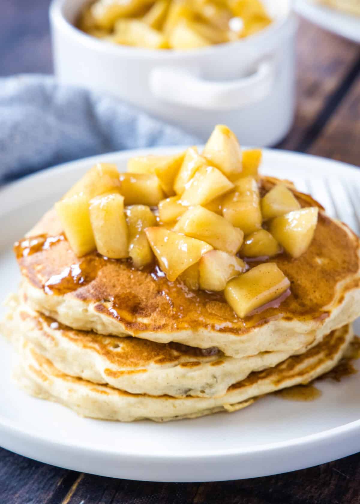 pancakes topped with apples on a plate
