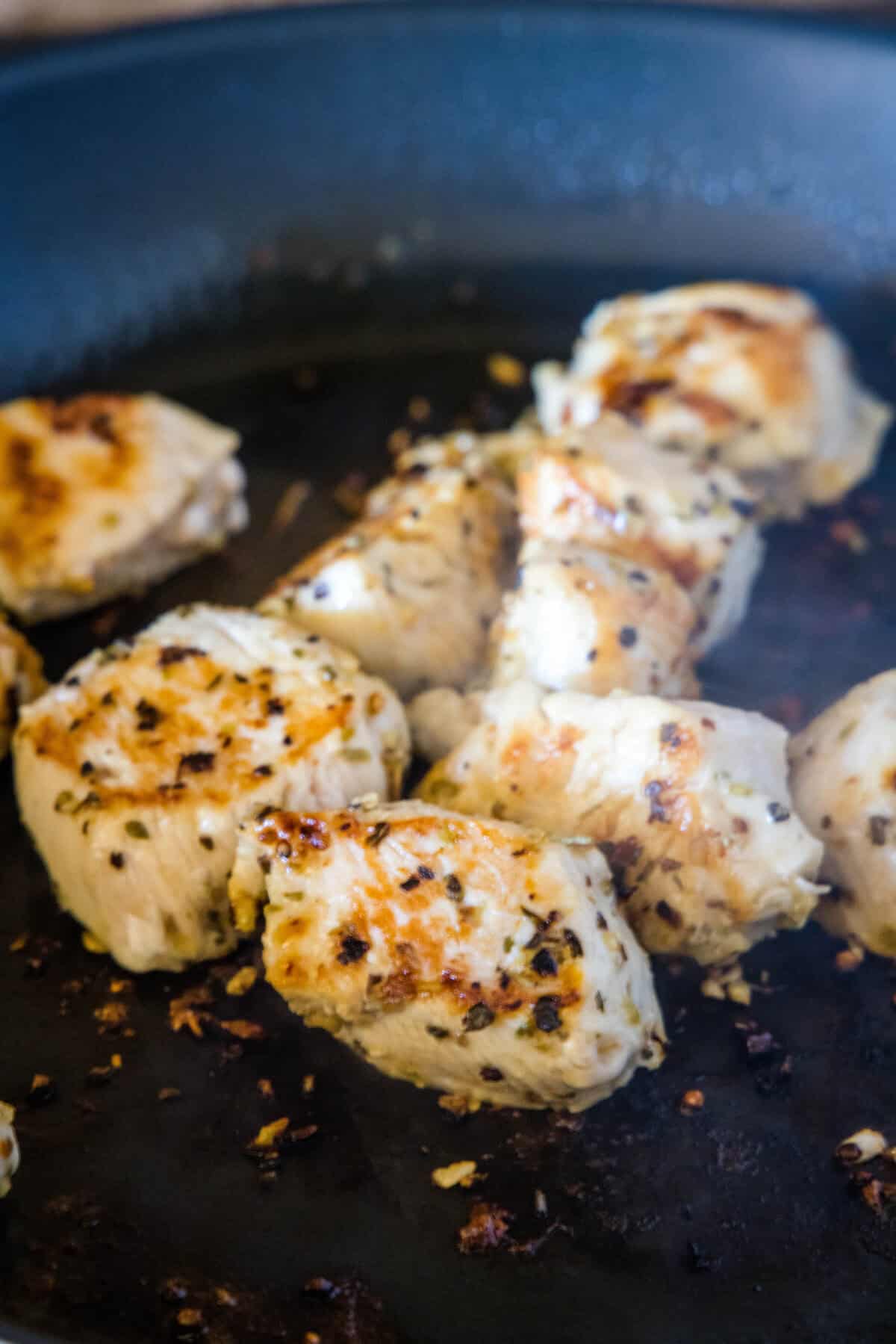 chicken cooking in a skillet