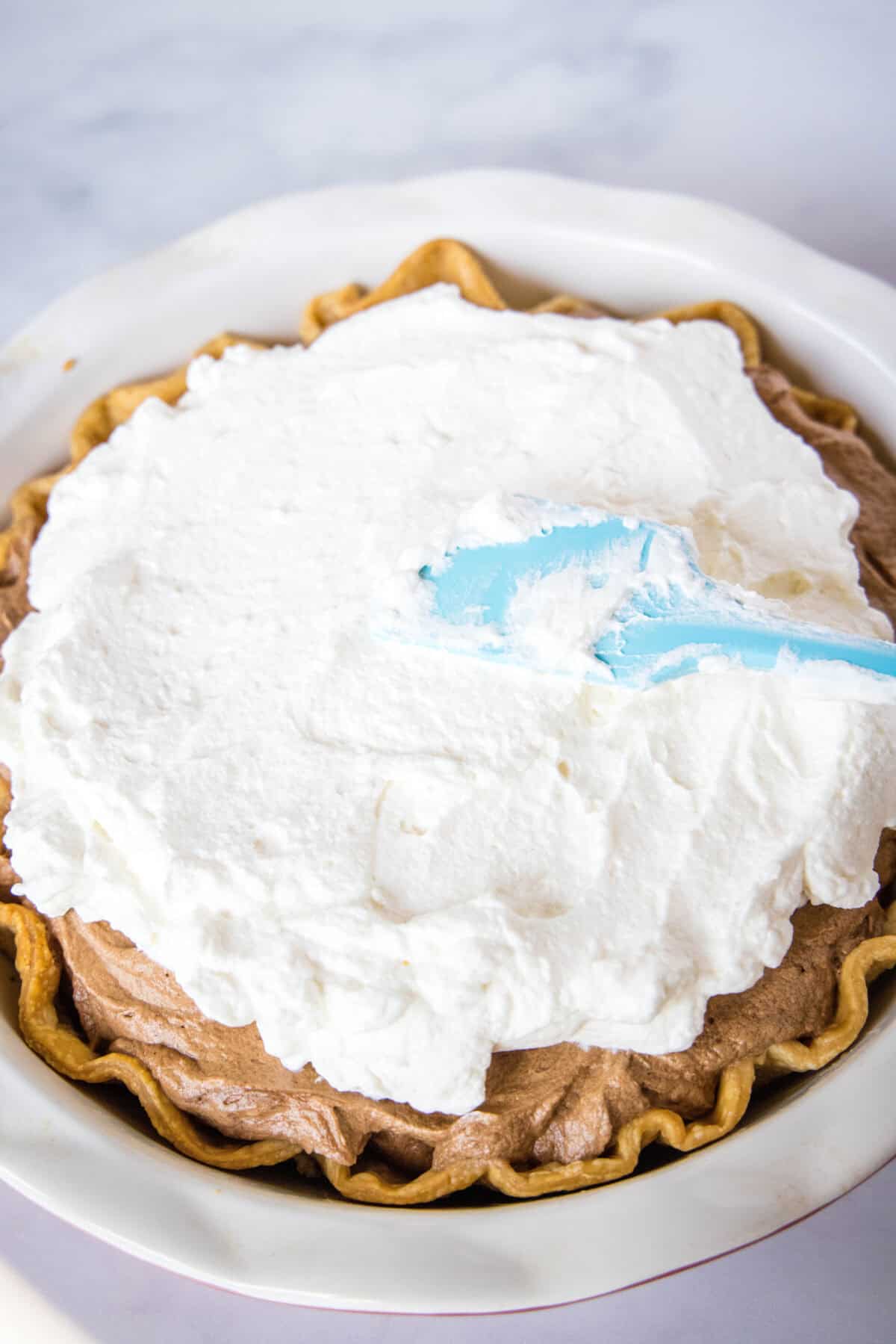adding whipped cream to french silk pie