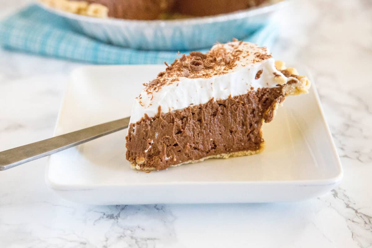 This French Silk Pie recipe is rich, creamy, and packed with chocolate flavor! A silky homemade chocolate mousse filling sits in a flaky pie crust and gets topped with fluffy whipped cream. It's an easy make-ahead dessert that's perfect for holidays, potlucks, or any day you're craving something decadent.