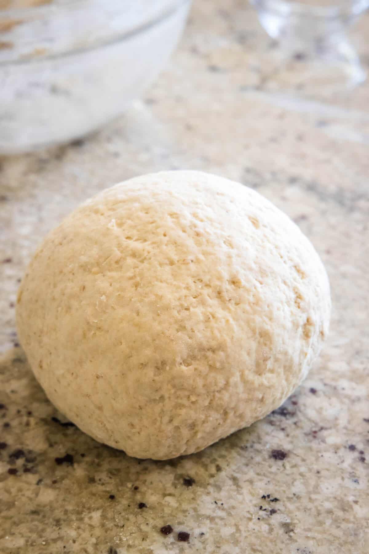 kneaded bread dough on counter