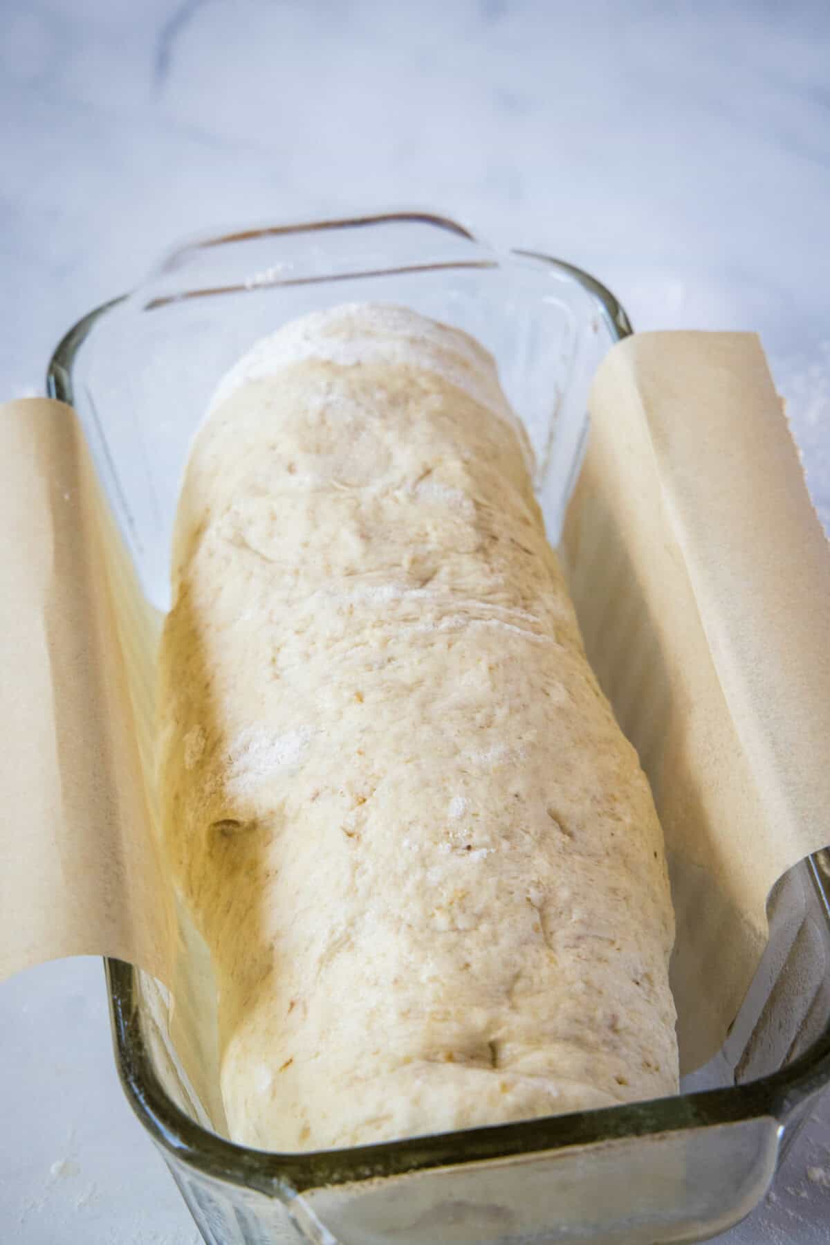 placing bread dough in baking pan for 2nd rice