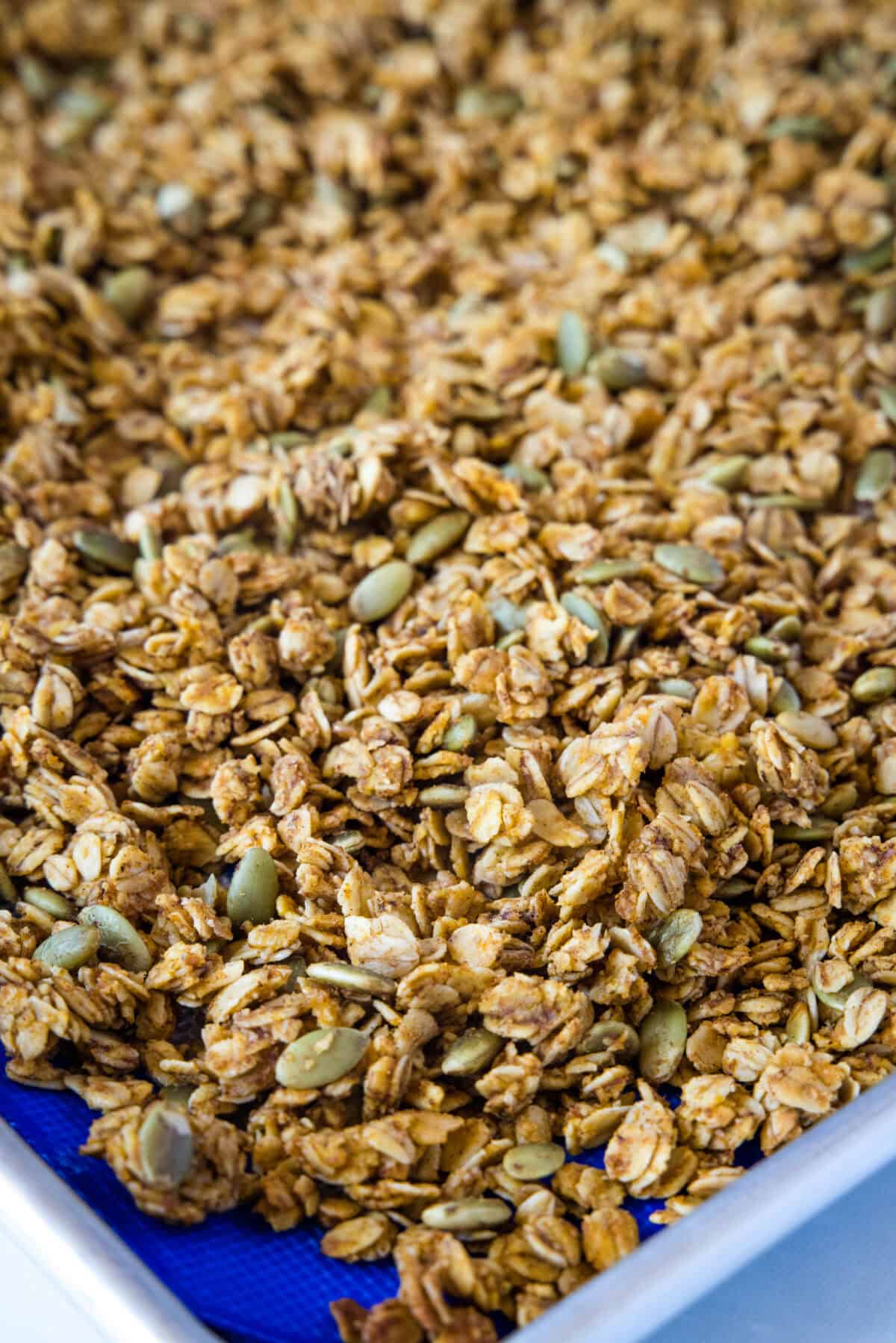 pumpkin granola on a sheet pan out of the oven