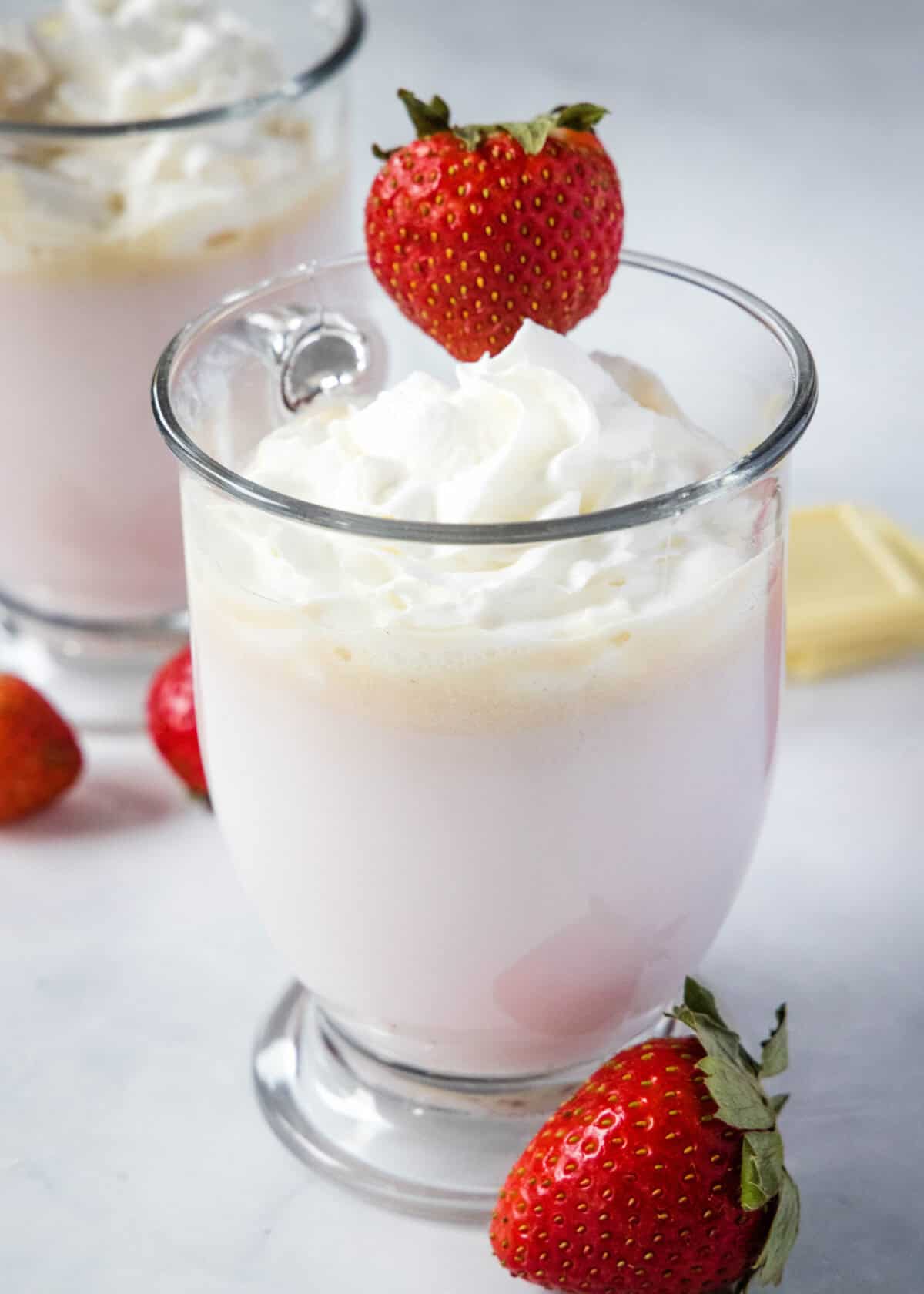 strawberry hot chocolate in a mug topped with whipped cream