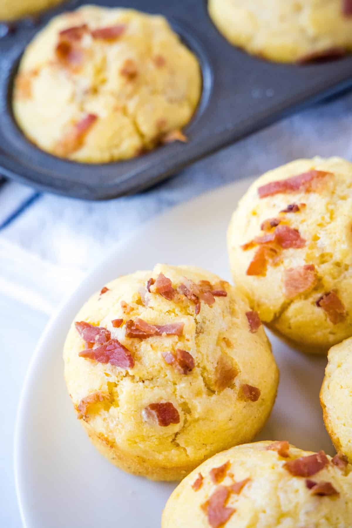 Bacon Cheddar Onion Corn Muffins | Dinners, Dishes, and Desserts looking down on plate with bacon corn muffins