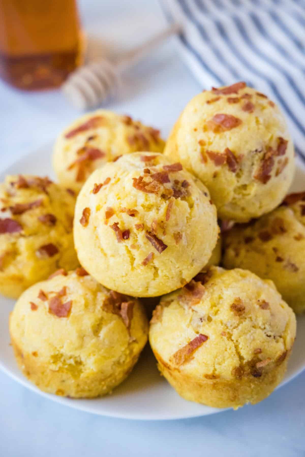 Bacon Cheddar Onion Corn Muffins bacon corn muffins on a plate to serve