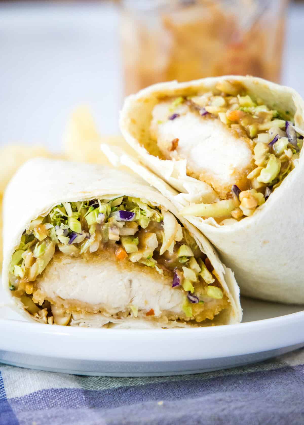 asian chicken wrap cut in half on plate