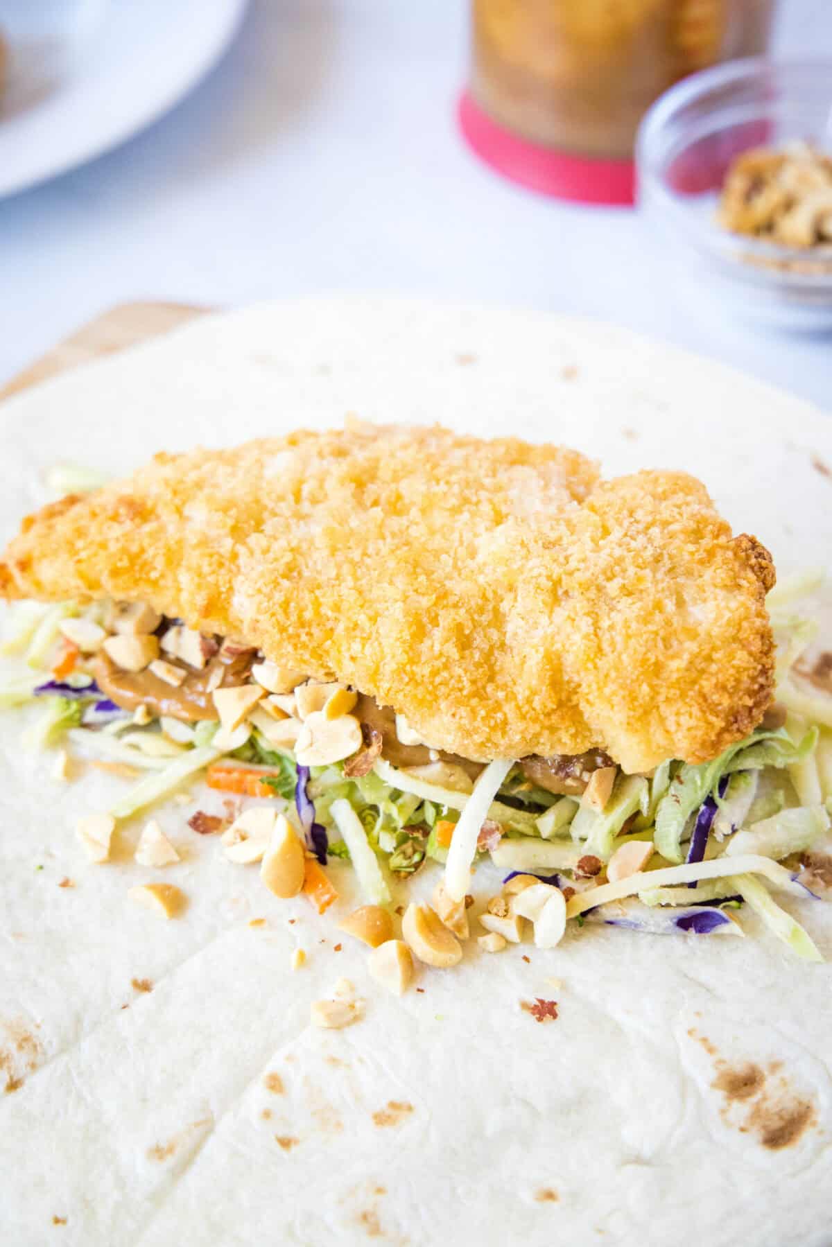 adding chicken and peanuts to wrap