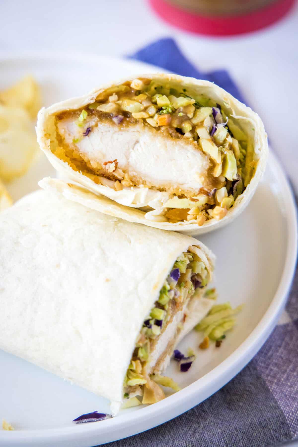 asian chicken wrap cut in half on plate