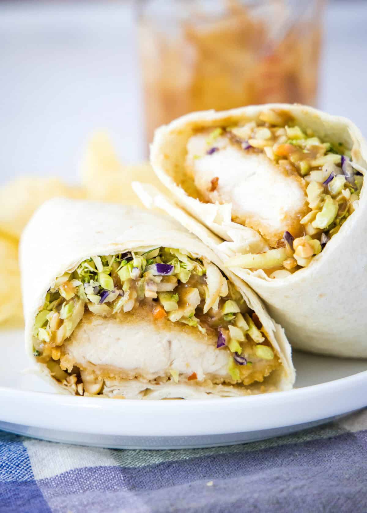 asian chicken wrap cut in half on plate
