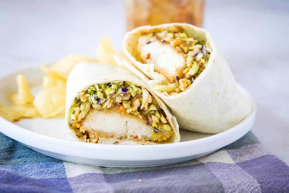 asian chicken wrap cut in half on plate