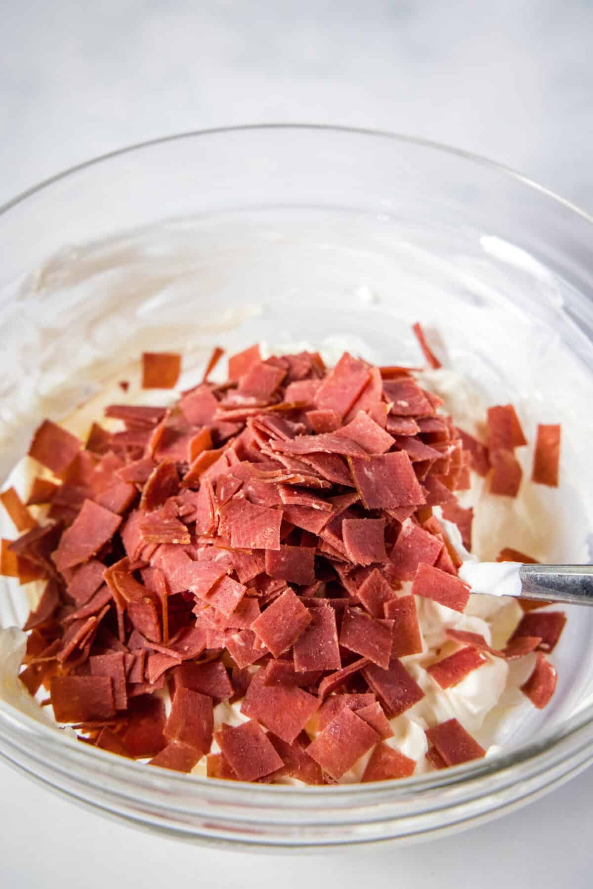 adding chopped beef to mixing bowl
