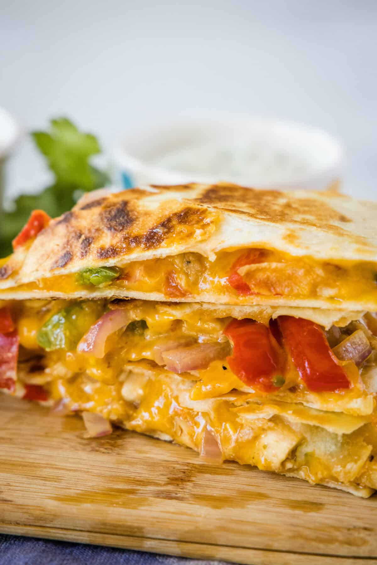 stacked chicken fajita quesadilla slices on a cuttin board