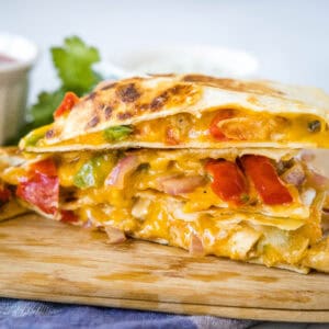 close up chicken fajita quesadilla on a cuttin board