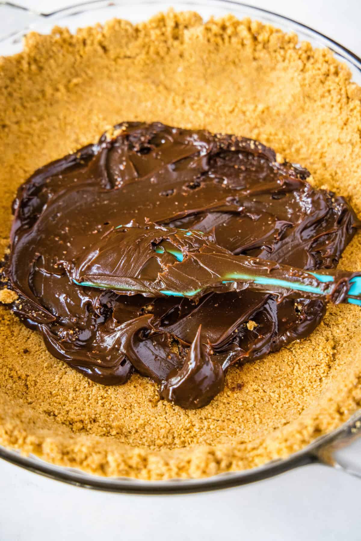 adding chocolate to a pie crust