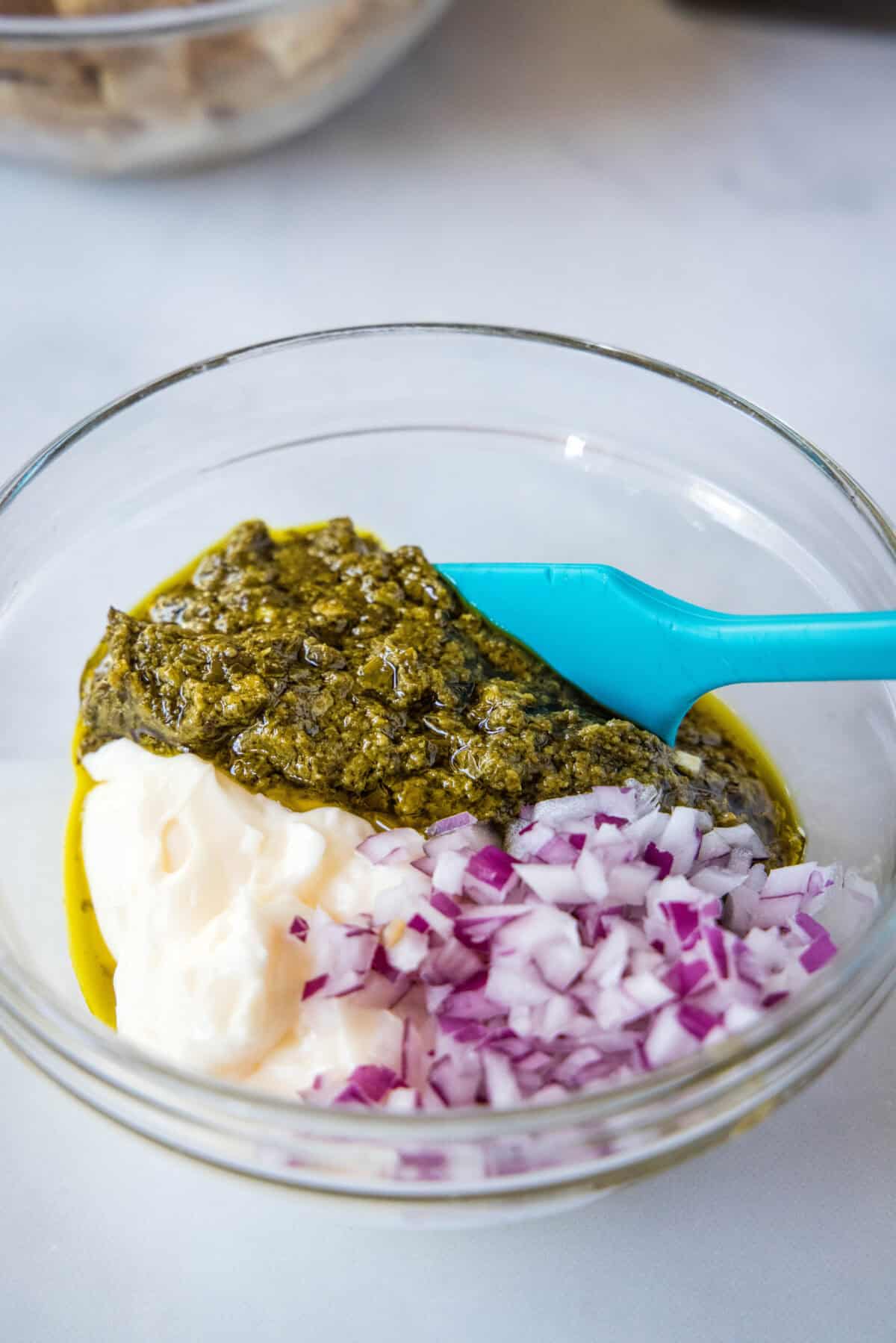 pesto chicken salad dressing ingredients in mixing bowl
