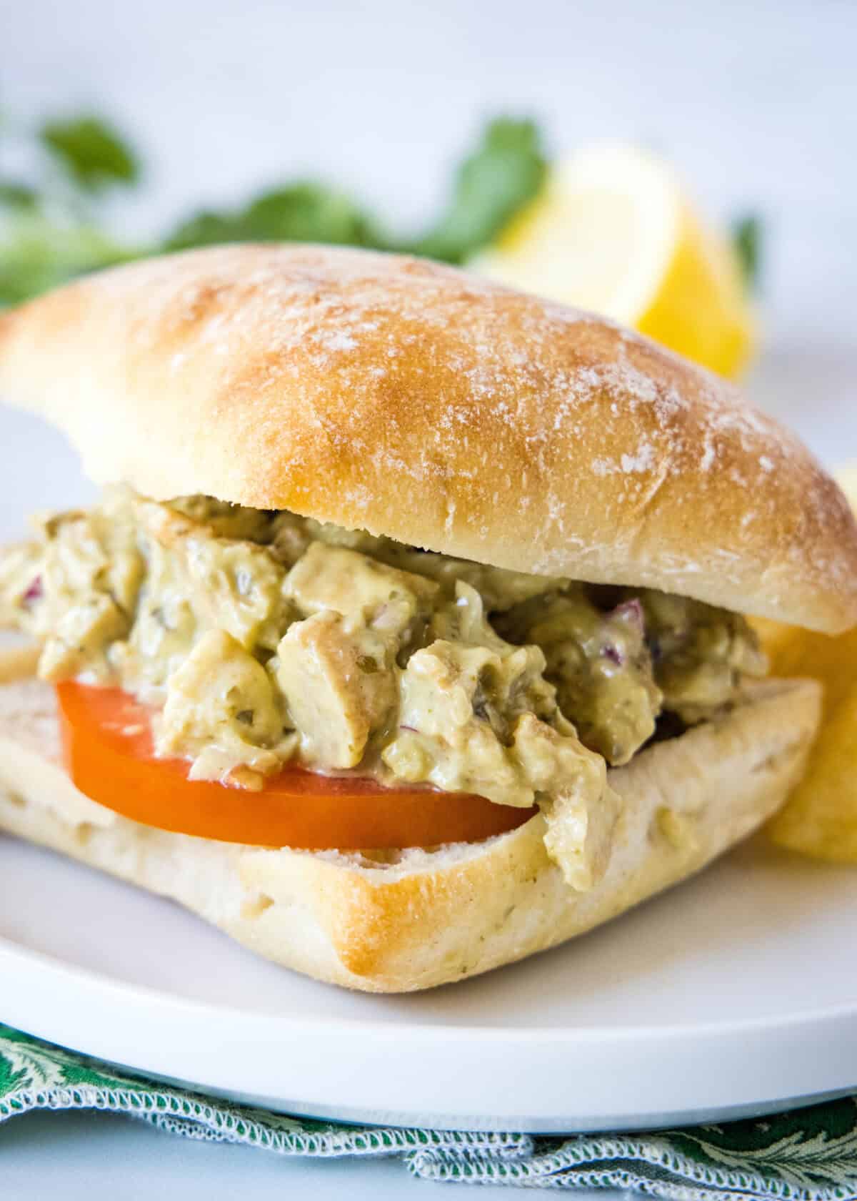 pesto chicken salad sandwich with tomato