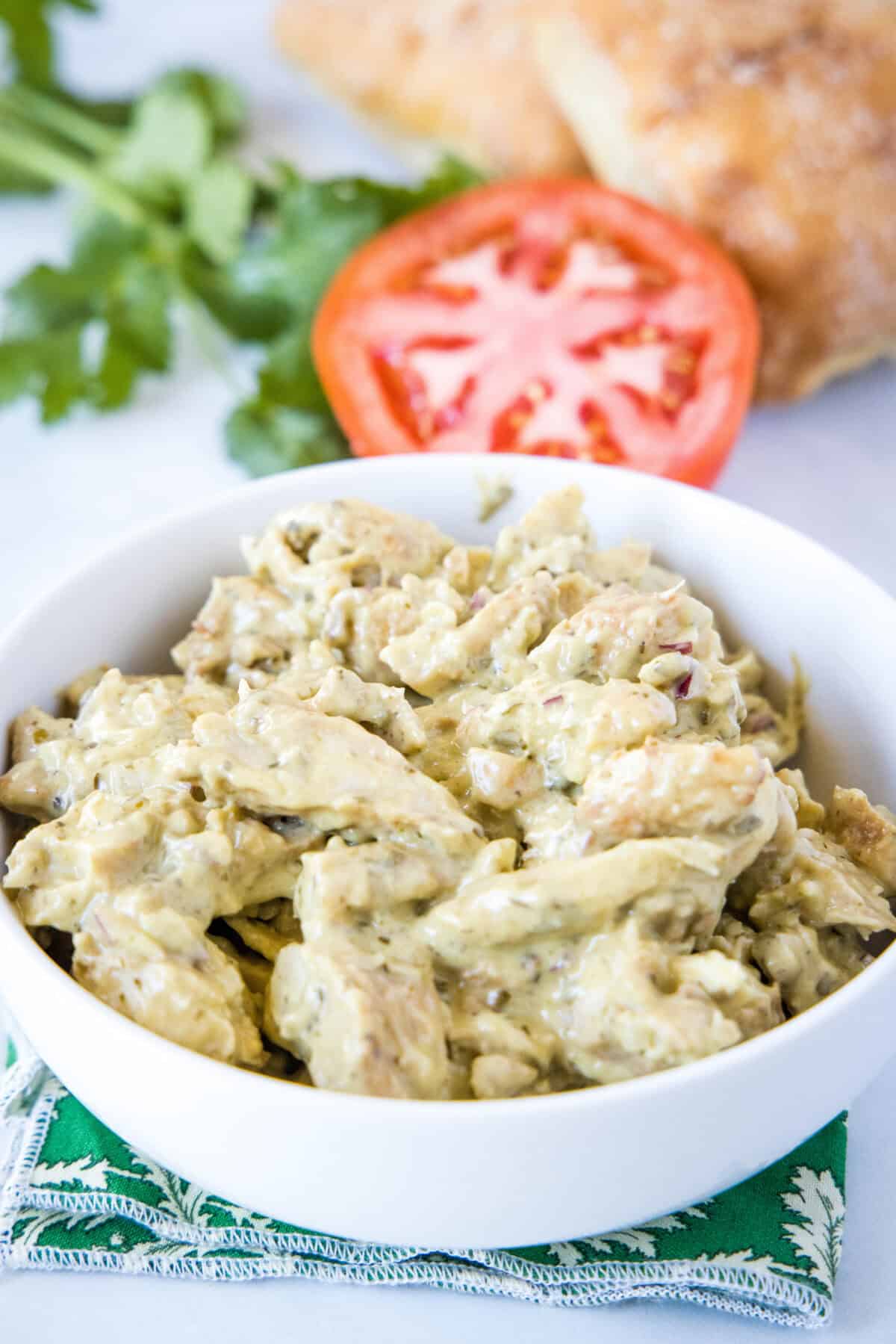 pesto chicken salad in a white serving bowl