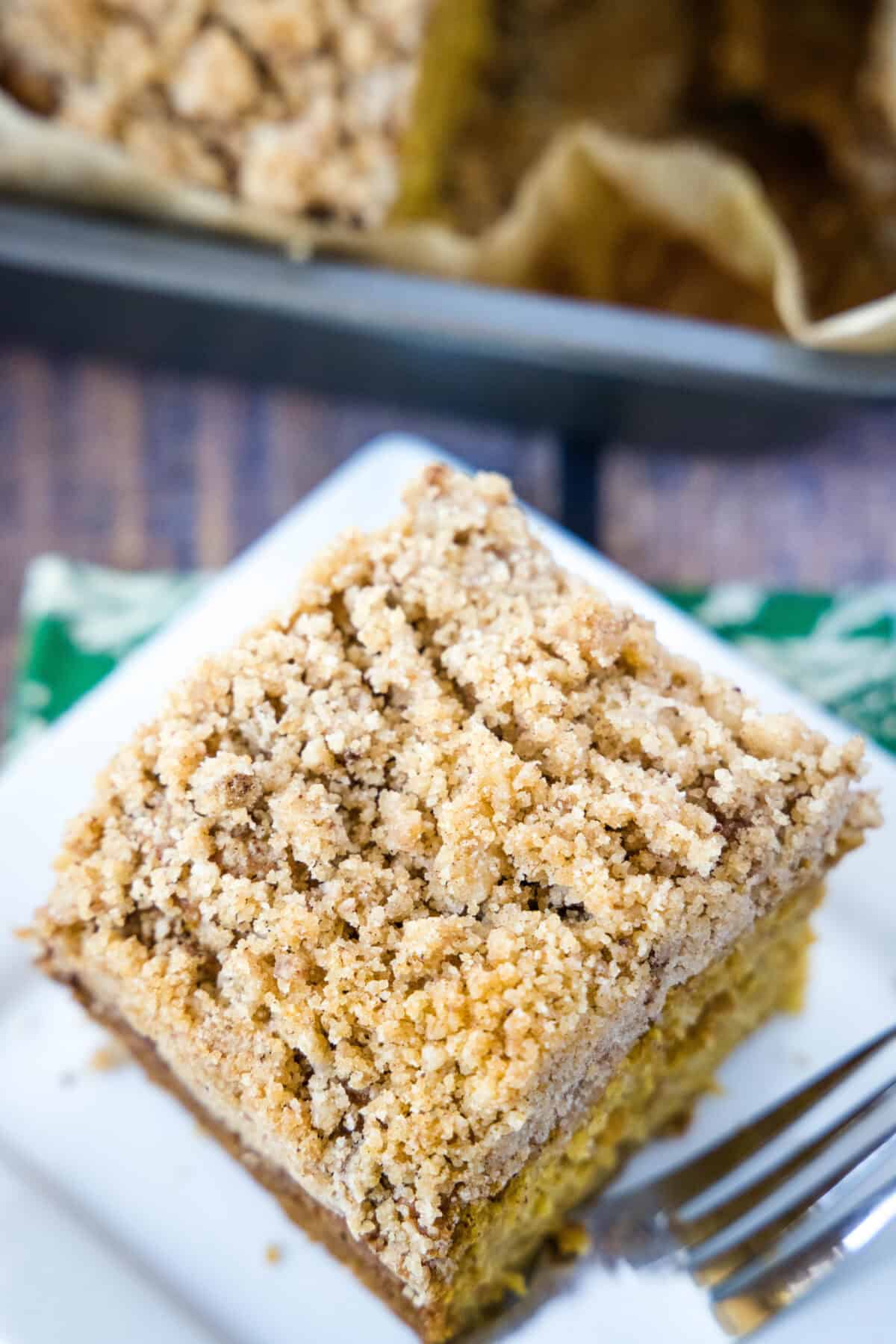 looking down on pumpkin coffee cake sliced on a plate