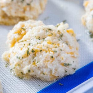 close up cheddar bay biscuit on baking sheet